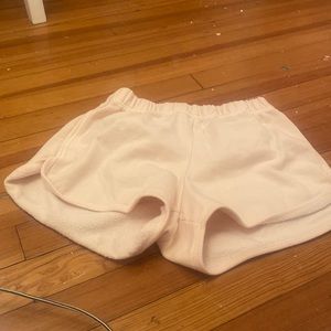 Light pink sweat shorts.